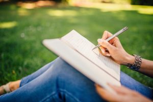 Woman sitting in park writing